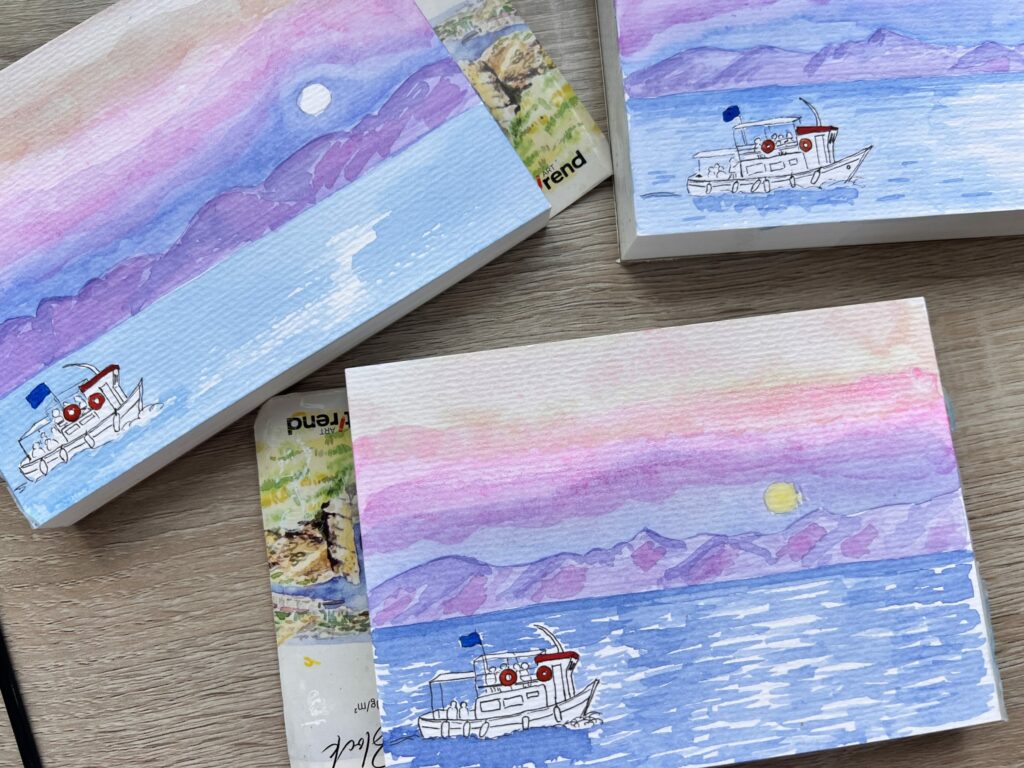 three tiny paintings of a boat on the sea in front of an island in the distance and the sky has sunset colours