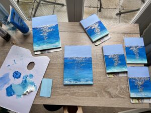 six sketchbooks with a seascape and glitter where the sun would make sparkles